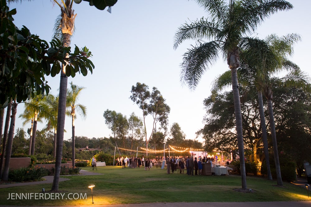 tented wedding on the lawn at rancho valencia resort and spa. photo shows string lighting effect at night