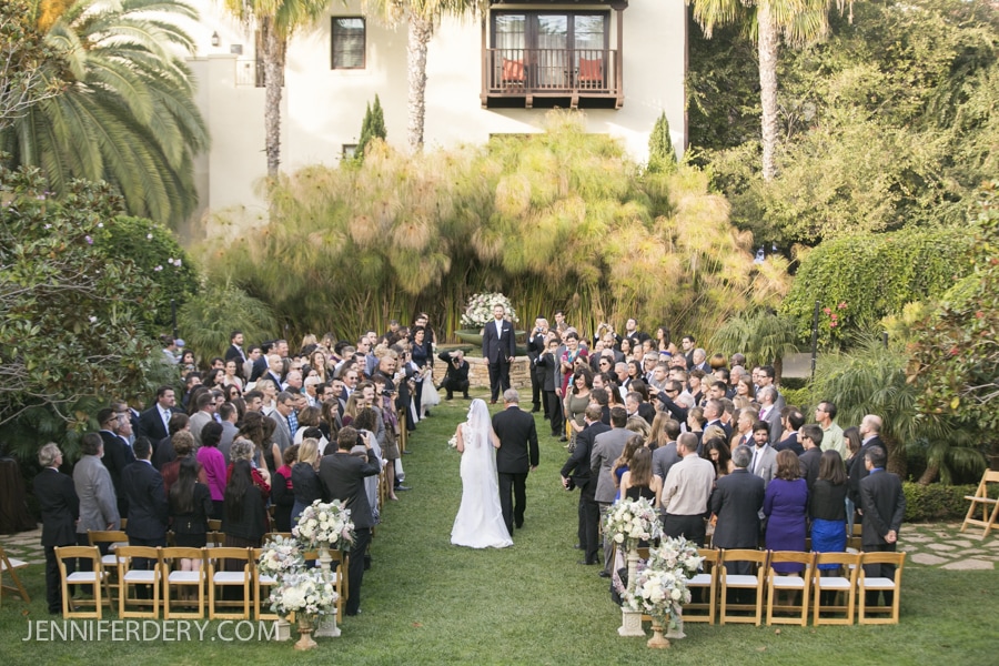 overhead view of the estancia la jolla wedding ceremony site as the bride and her father walk down the aisle.