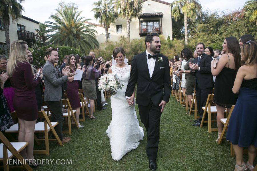 bride and groom recessional as the walk down the aisle at Estancia La Jolla wedding ceremony outdoors.