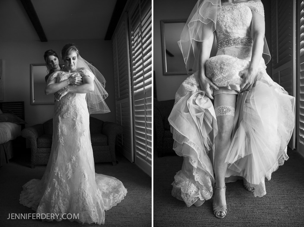 black and white photo of bride getting dressed - lace wedding gown and garter