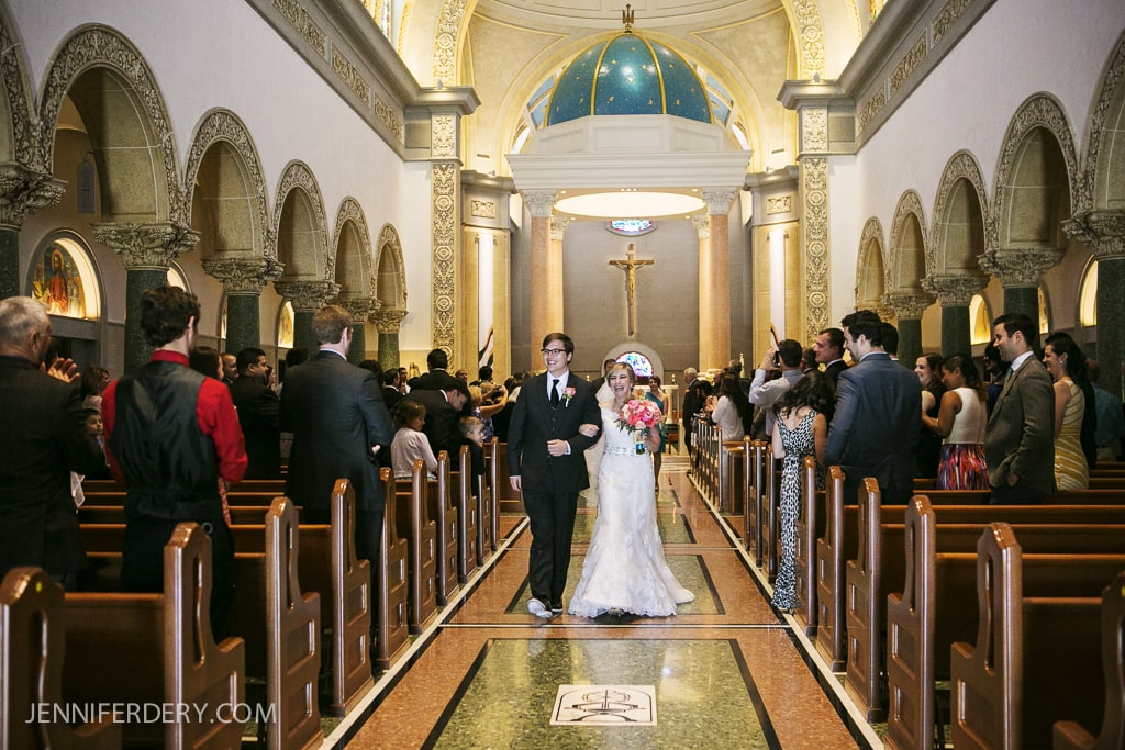 photo of bride and groom leaving the church - recessional - Immaculata USD