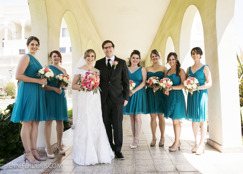 Photo of bridesmaids in teal / turquise short dresses. Customized designs