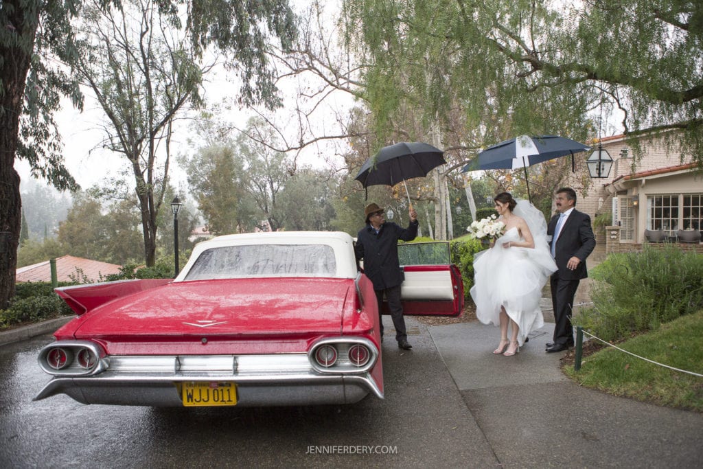 bride leaving for her wedding. getting into a vintage red convertible. leaving rancho bernardo inn
