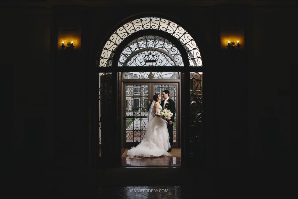 wedding couple standing inside founders hall at usd california during a wedding photo session