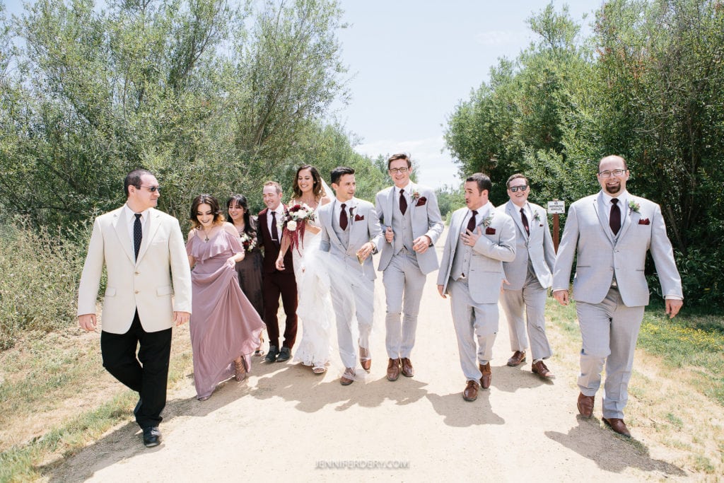 bridal party walking together at ra ancho guajome adobe wedding