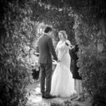b&W phot of a couple shown inside the garden during their wedding ceremony at the thursday club in point loma.