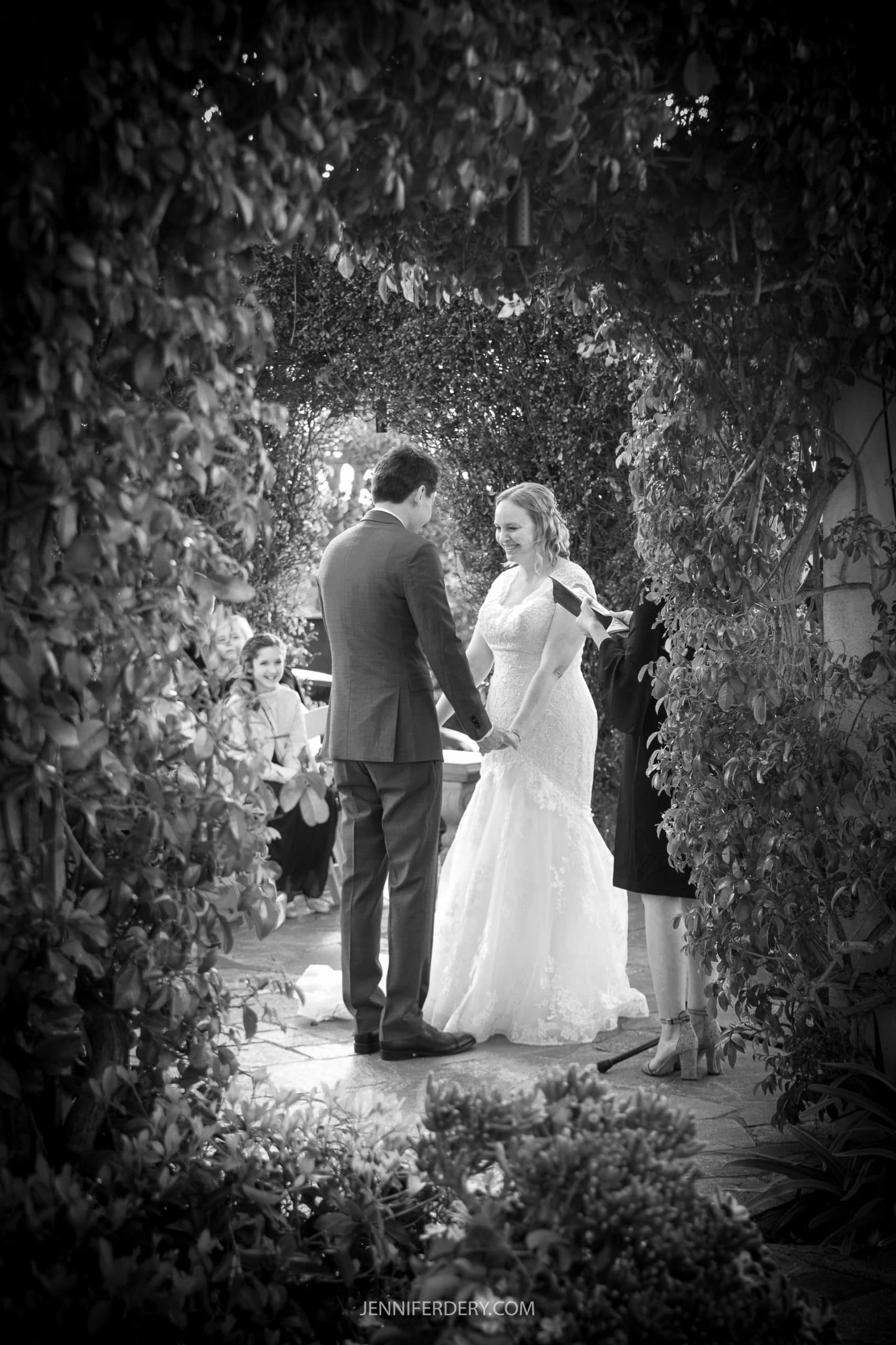 b&W phot of a couple shown inside the garden during their wedding ceremony at the thursday club in point loma.