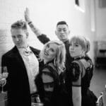 black and white documentary photography of four friends posing dramatically at wedding at the guild hotel ballroom