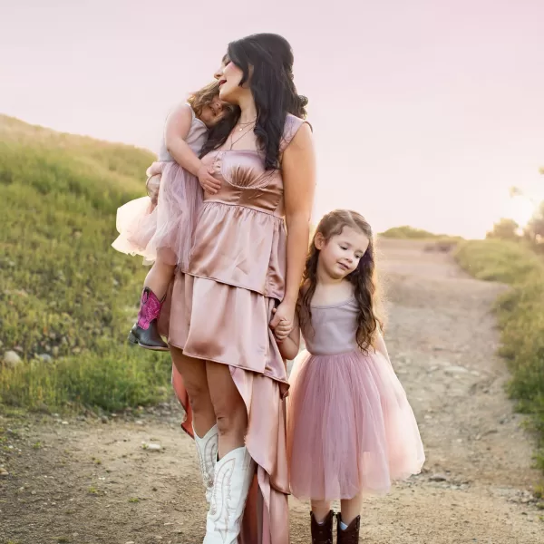 photo of a mother and two daughters during a portrait session wearing rose gold dress