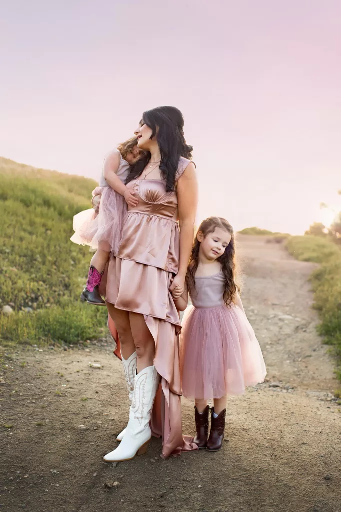 San Diego Family Photo of a mama Session with her two daughters in a field. everyone dressed in pink with a pink sunset