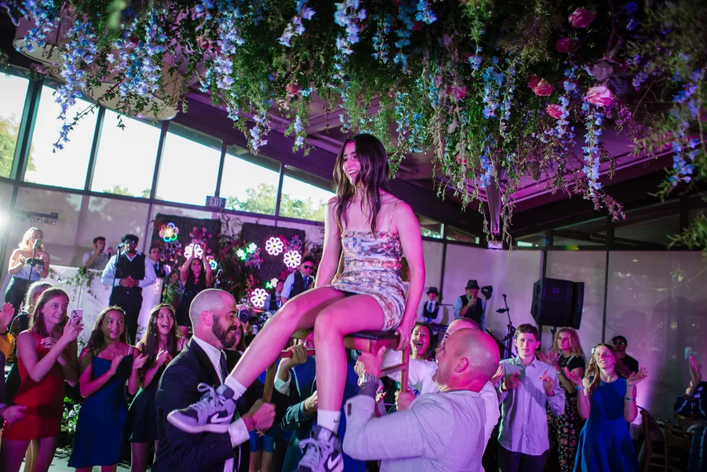 Palo Alto Bat Mitzvah for Megan shown during the hora surrounded by a ceiling of flowers and a circle of friends