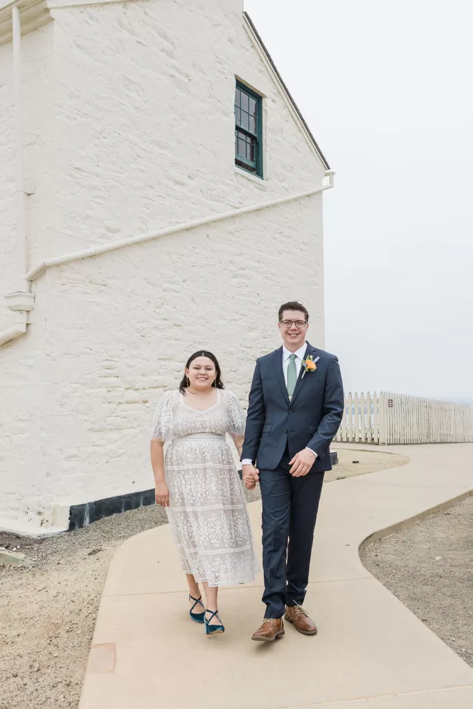 elopement photo of a bride in san diego at cabrillo monument park with the lighthouse in the background