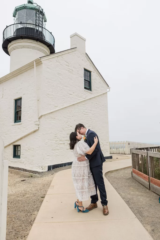 elopement photo of a bride in san diego at cabrillo monument park with the lighthouse in the background