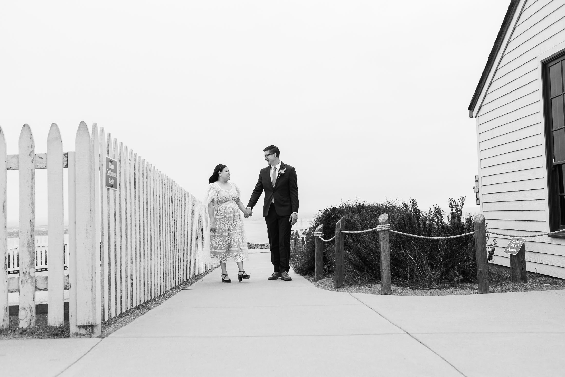 elopement photo of a bride and groom in san diego shown at cabrillo monument lighthouse in black and white