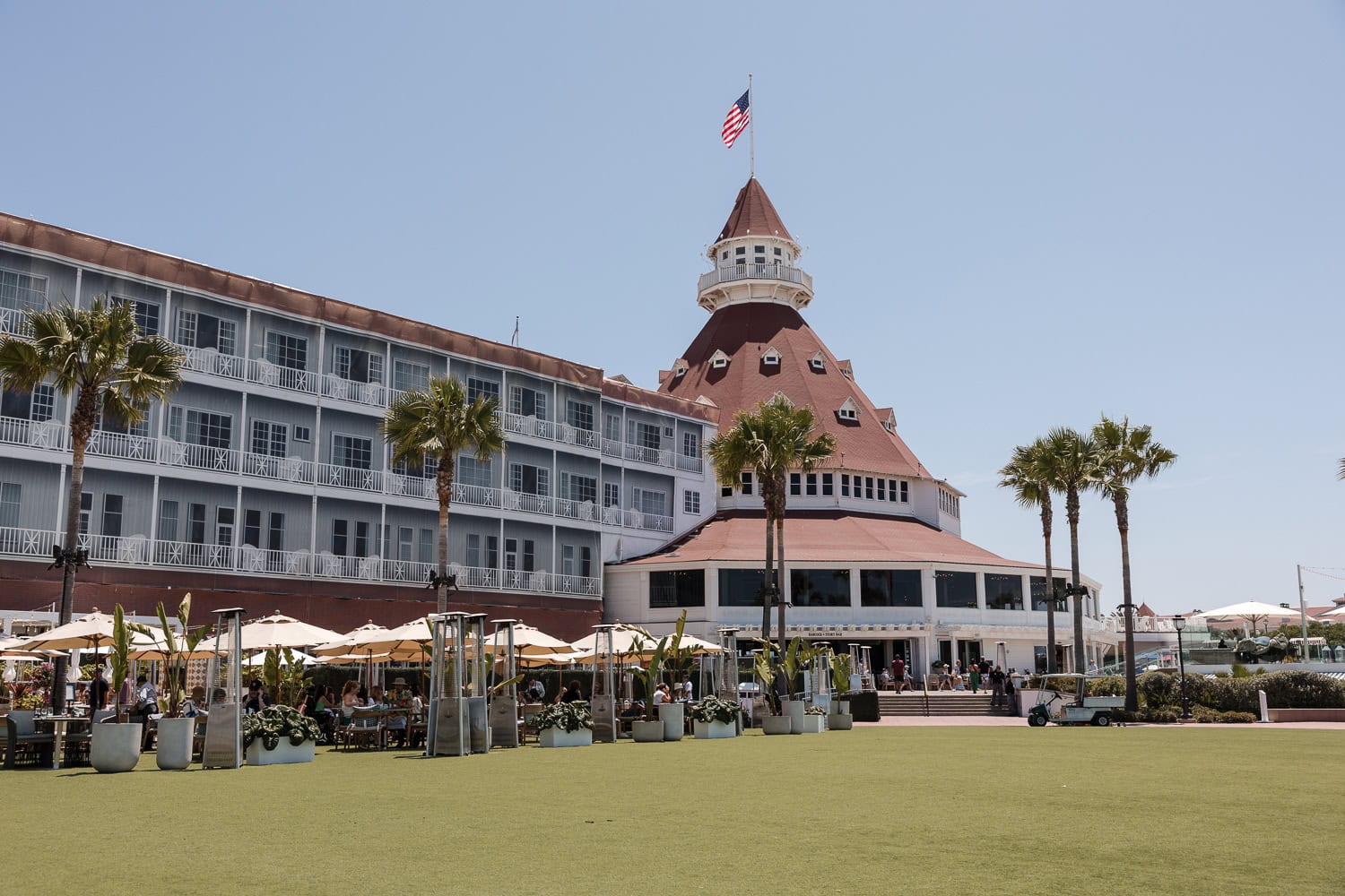 hotel del coronado front lawn with restaurant in the background cleared for cocktail reception setup