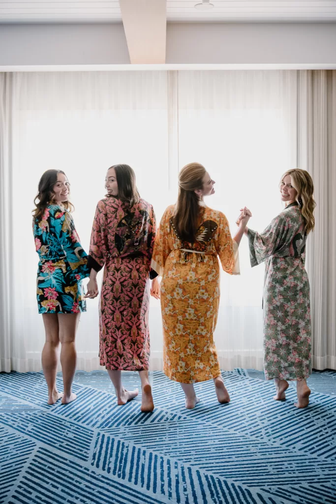 photo of bridesmaids in colorful mis-matched robes for getting ready