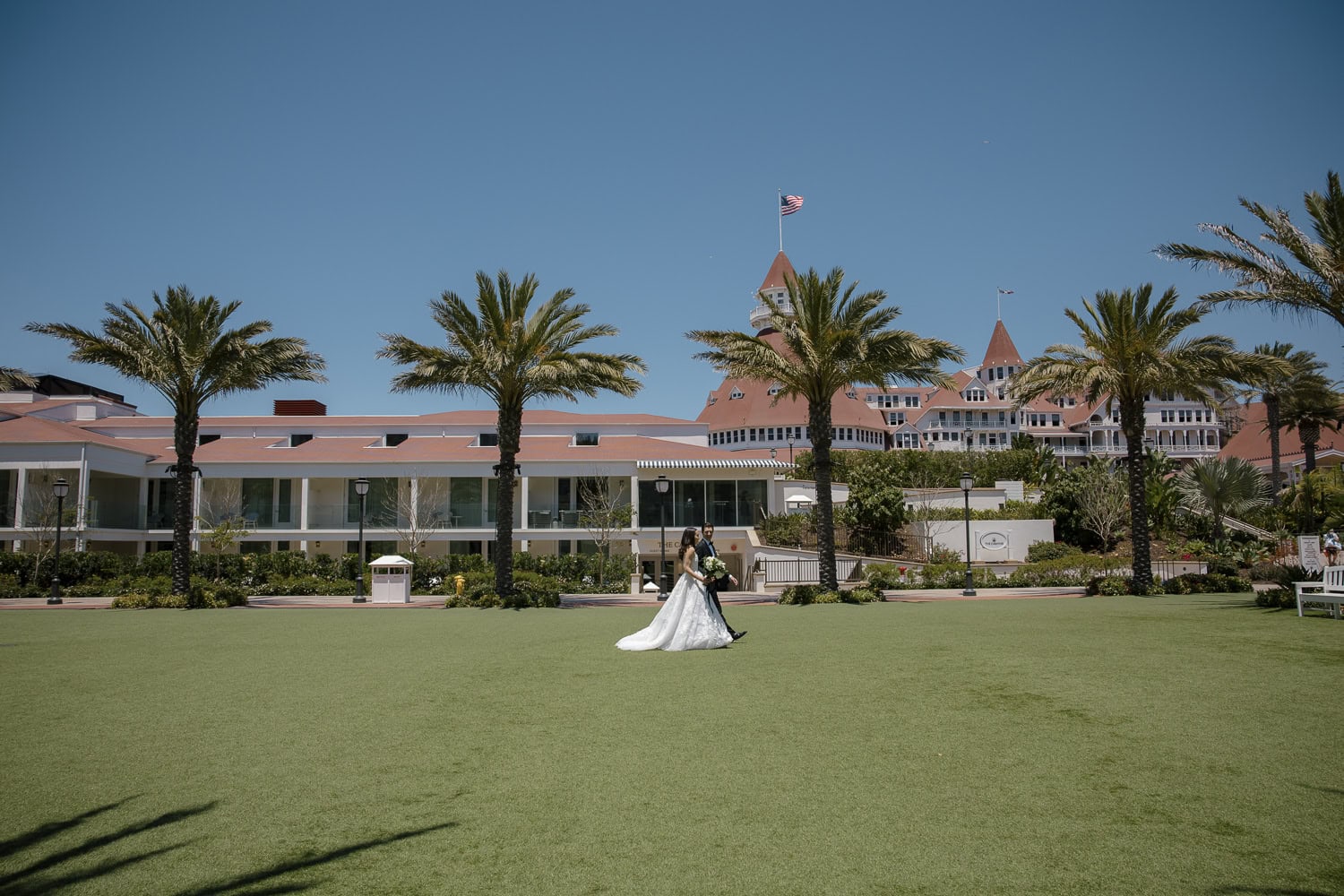 wedding couple on lawn outside of Southpoint Event Center hotel Del Coronado