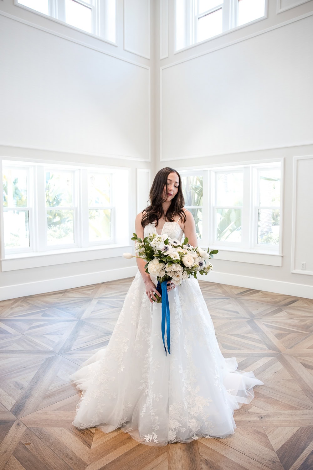 Southpointe Ballroom foyer Wedding dress and flowers in navy and white at the Hotel Del Coronado