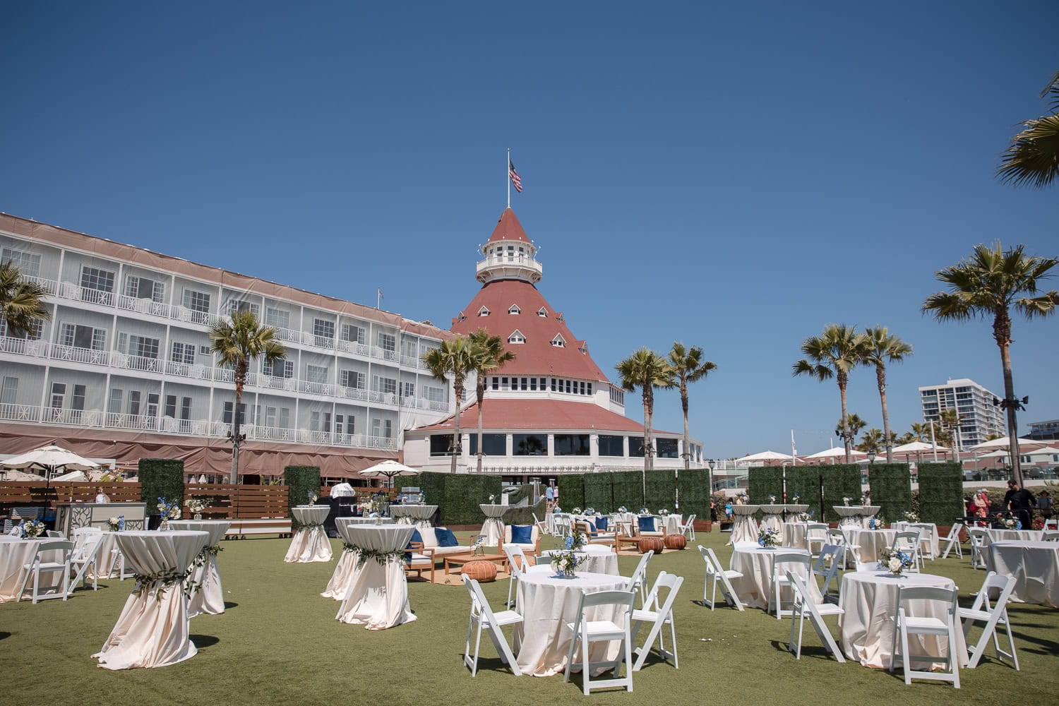 cocktail hour set up on grand lawn at the hotel del in navy, white, and brown