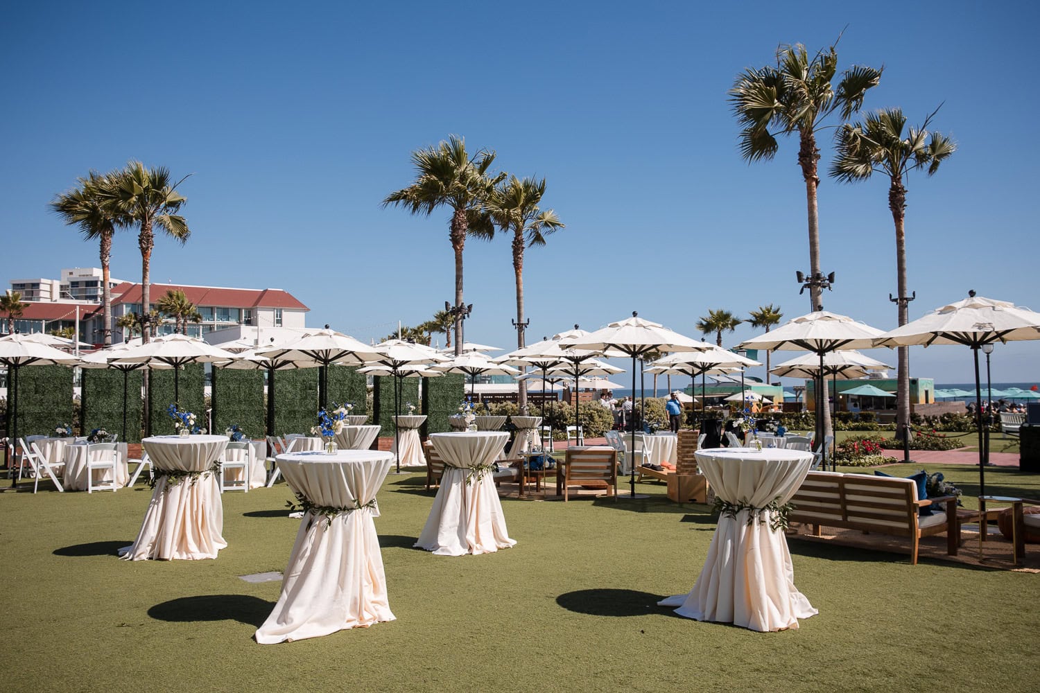 cocktail hour set up on grand lawn at the hotel del in navy, white, and brown