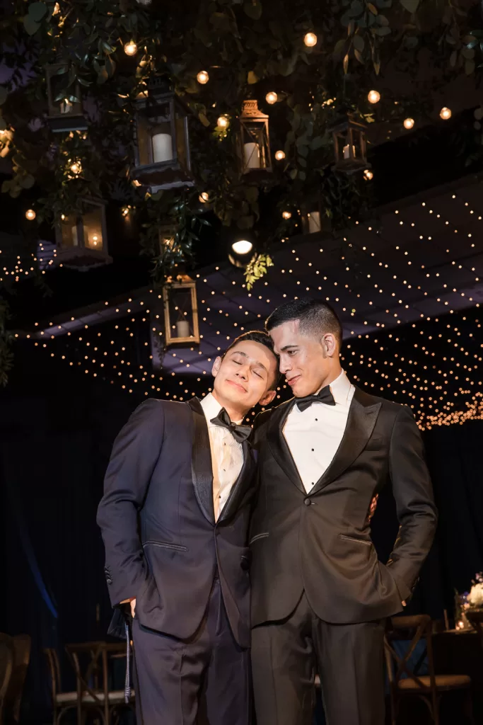 photo of event planners and coordinators, Alex and Jacob in the navy draped ballroom of southpointe ballroom at the hotel del coronado, CA