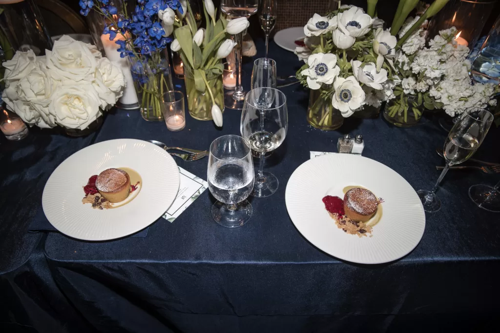 Southpointe Ballroom event center decor using navy and white with candles and plated desserts