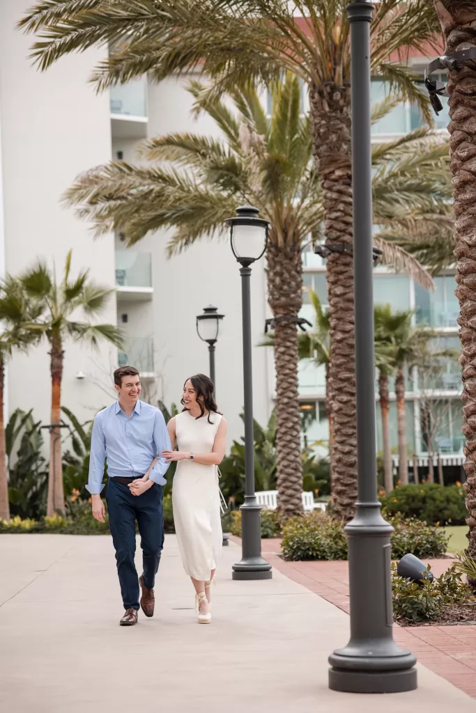 destination engagement session at the hotel del coronado in san diego, california. couple walking arm in arm.