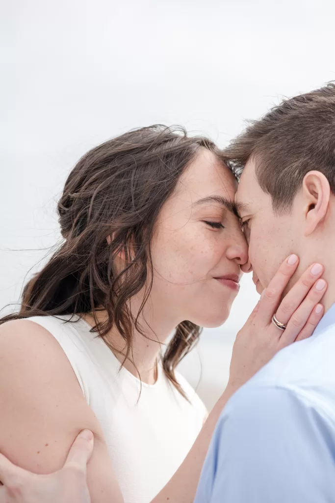 destination engagement session at the hotel del coronado in san diego, california. photo of a couple snuggling close up