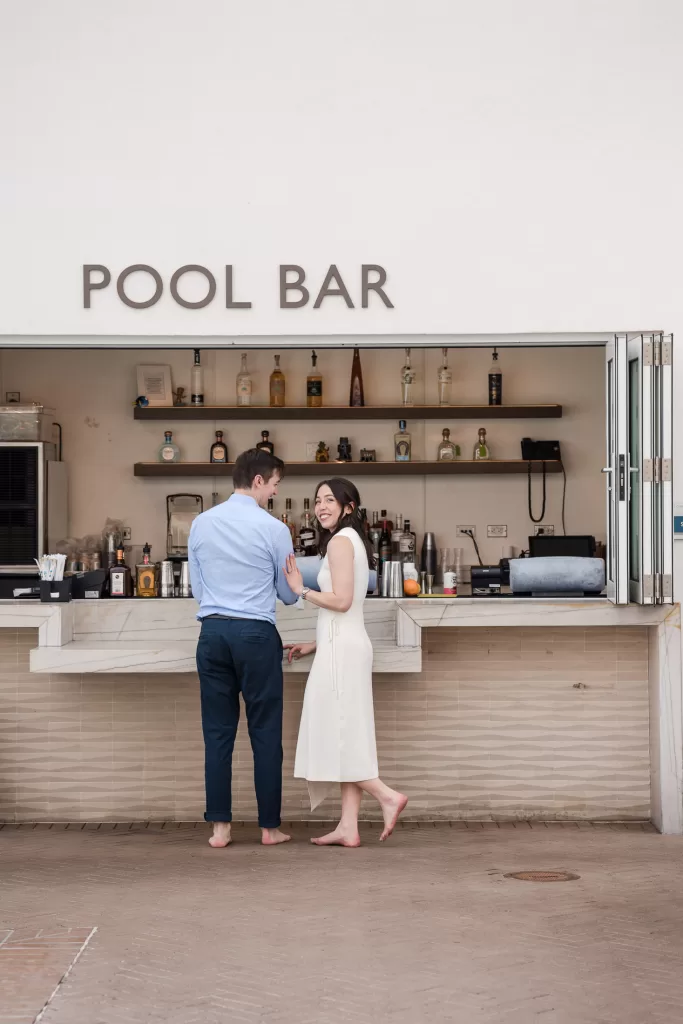 destination engagement session at the hotel del coronado in san diego, california. photo of a couple ordering at the pool bar